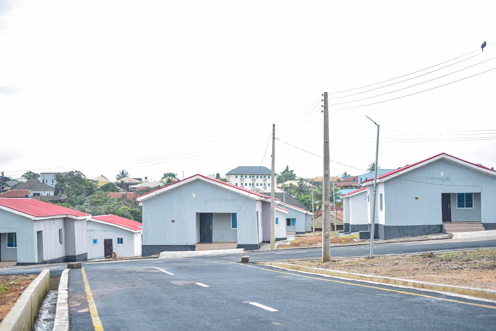 Completed bungalows along a paved estate road with street lights